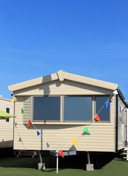 Modern static caravan in trailer park with bunting.