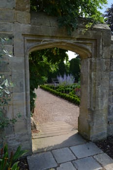 Ancient doorway set in formal grounds of a English Manor House.