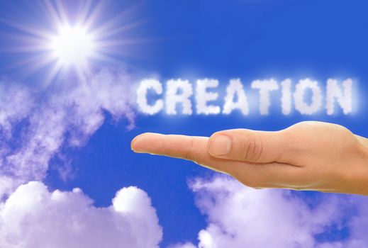 Creation written with clouds with bright sun rays 