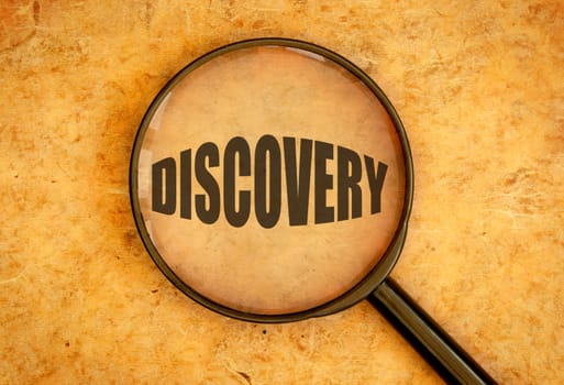 Magnifying glass focused on the word discovery