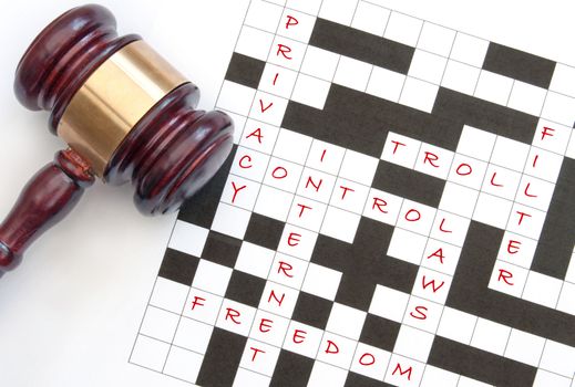 Crossword with issues relating to the internet with a gavel on one side 