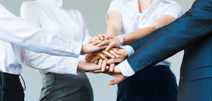 concept of teamwork. business people joined hands