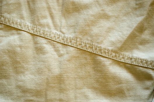 closeup of bright pant fabric stitch background.