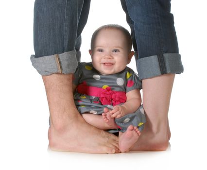 young family - baby sitting between legs of mom and dad isolated on white background