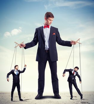 Image of young businessman puppeteer. Leadership concept