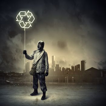 Man in respirator against nuclear background. Recycle concept