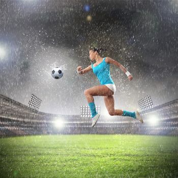 Image of young woman football player hitting ball