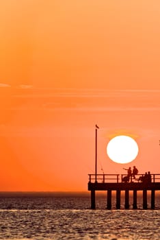 Fishing While the Sunset Sets of the sea