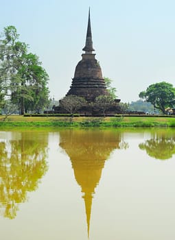 Pagoda reflected in the pond at  Sukhothai Historical Park . Thailand