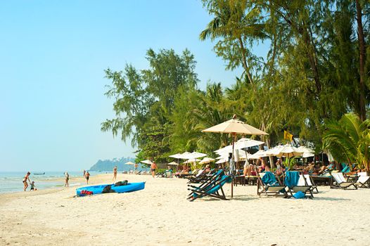 KOH CHANG ISLAND, THAILAND - FEB 02: People on the beach on Feb 02, 2013 in Koh Chang island, Thailand. Almost 20 million tourists visited Thailand in 2012.