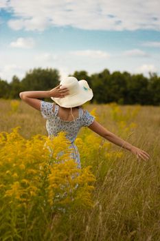 Portrait of beautiful young woman in the field