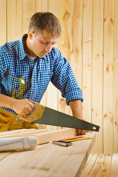 worker works with handsaw