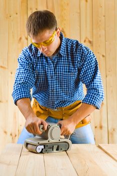 young men works with detail sander