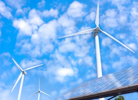 Renewable resource technologies: wind turbines and solar cells in wind farm.