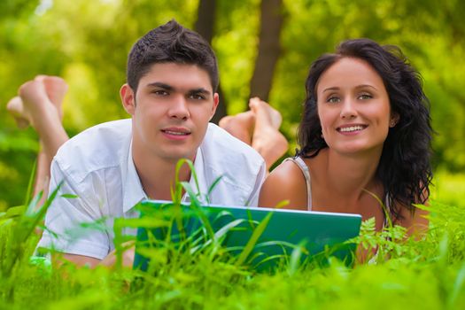 Young couple lying and enjoying at park