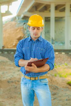 a young worker writing in clipboard