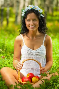 beautyful female holding basket of apples