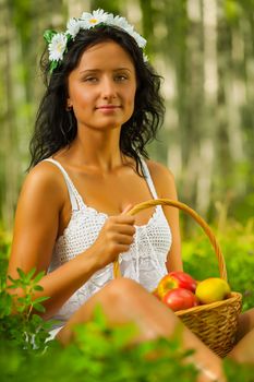 brunette holding basket with apples