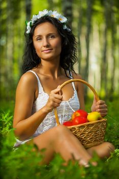 brunette on grass with apples