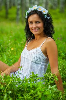 brunette sitting on grass