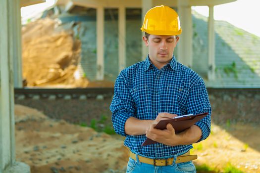 contractor writing in clipboard