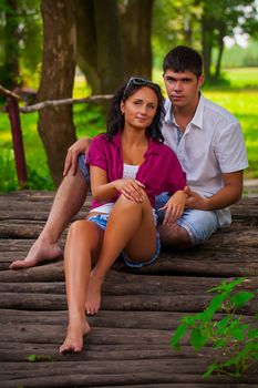 couple sitting on wooden logs