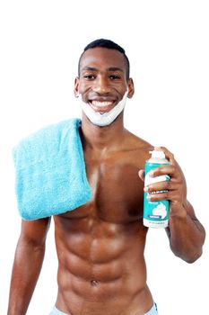 A handsome black man, holding a can of shaving cream, with shaving cream applied to his face.