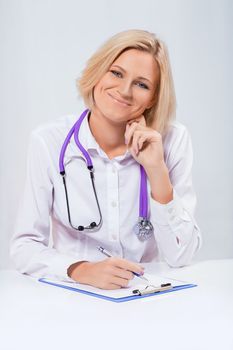 friendly female doctor sitting at the table