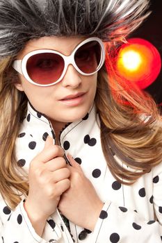 Beautiful woman with white sunglasses and heiry hat, dots jacket