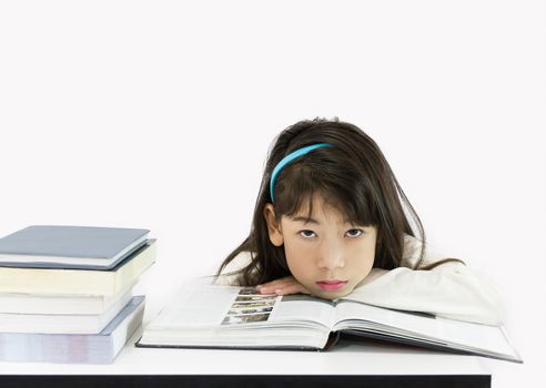 The young student reading the book on a white background