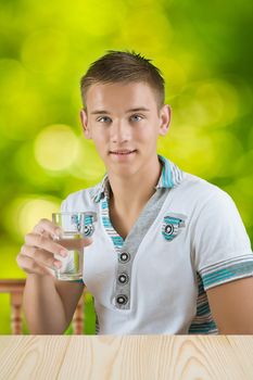 a guy holding glass of water