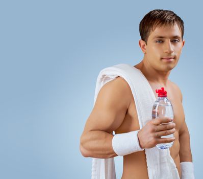 a muscular handsome man with bottle of water