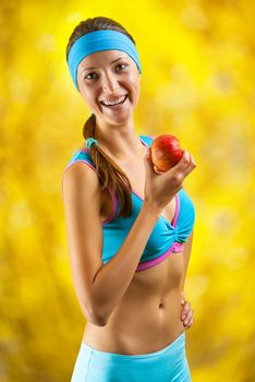 a sports girl holding an apple