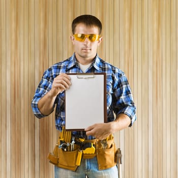 a worker holds clipboard