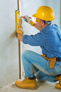 a worker layering on concrete wall