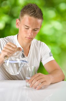 boy filling water in the glass