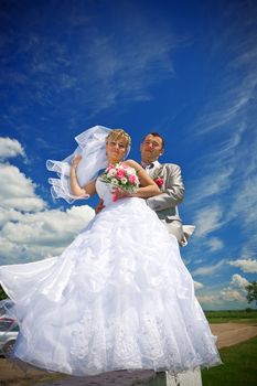 bride and groom on the sky