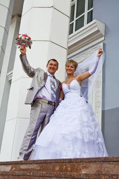 bride and the groom on a background of a building