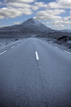 road to the Errigal mountains in county Donegal Ireland on a bright cloudy day