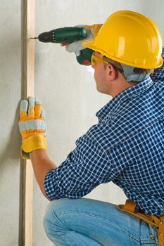 man drilling wall