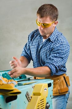 men works on woodworking mashine