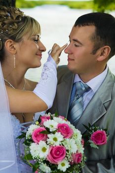 The bride looks after the groom