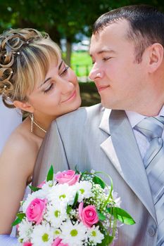 The groom and the bride look against each other