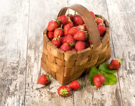 basket of strawberries on background of the old wooden table