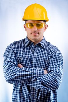 worker in a hardhat and yellow goggles