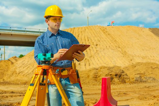 a contractor writing in  clipboard