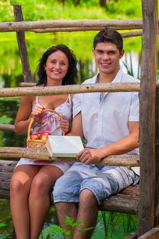 a couple sitting on wooden bridge