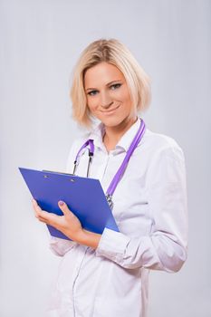 a female doctor holding clipboard