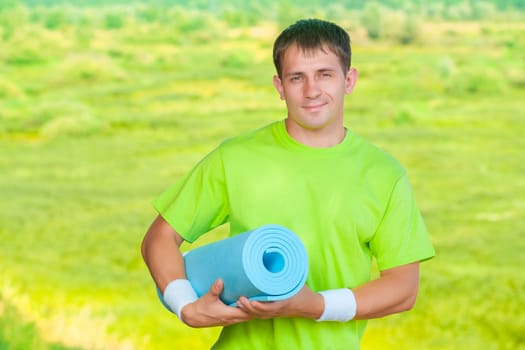 a sportsman holding yoga mat