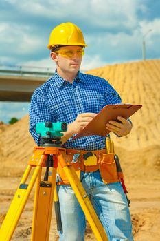 a worker writing with a ballpoint pen in clipboard